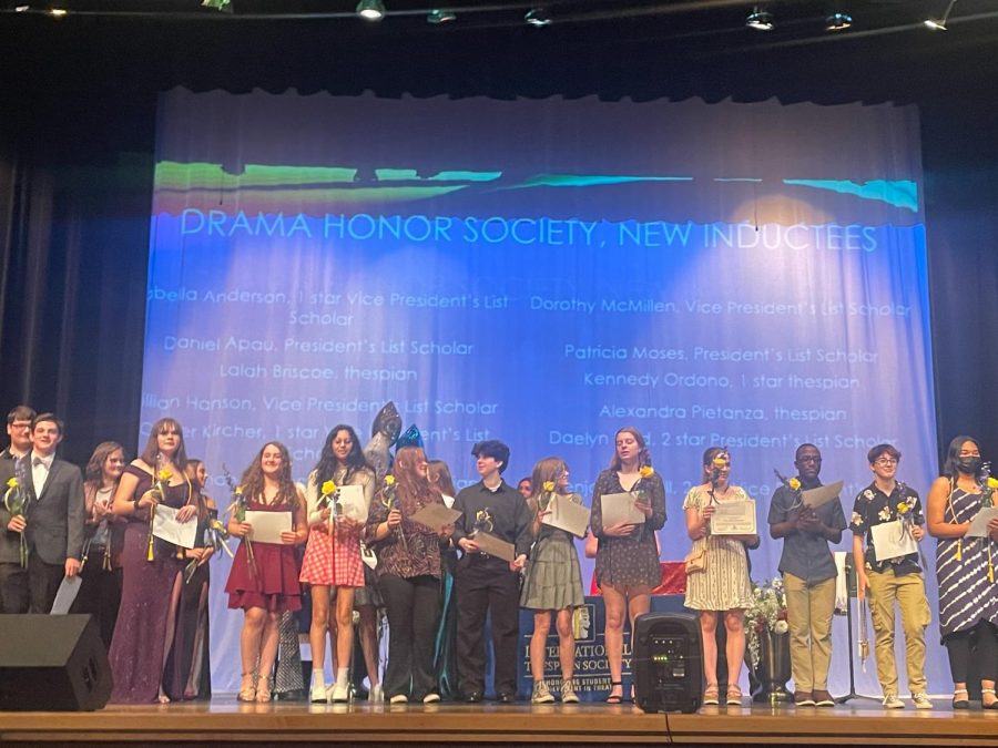 All+of+the+new+inductees+of+the+International+Thespian+Society+stand+on+the+apron+of+the+Linganore+stage.+