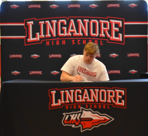 Joel Hopkins signs his Letter of Intent to wrestle at Frostburg State University.