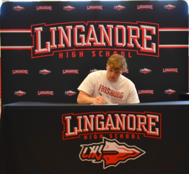 Joel Hopkins signs his Letter of Intent to wrestle at Frostburg State University.
