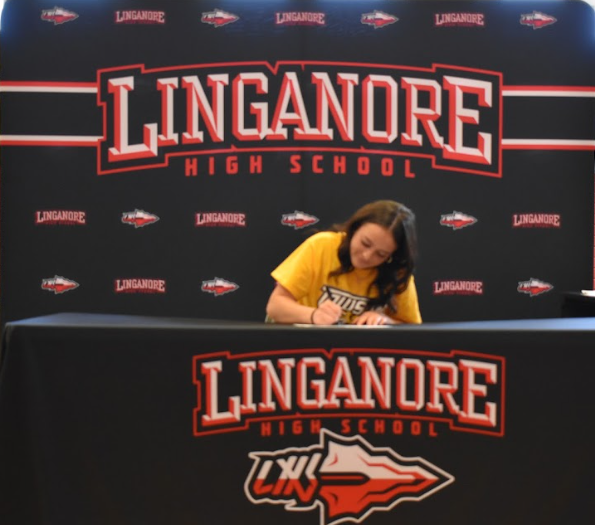 Lilah Covey signs her National Letter of Intent to cheer at Towson University.