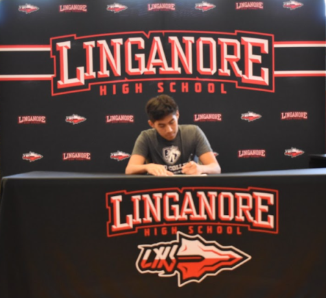 James Martinez signs his National Letter of Intent to swim at Hood College.