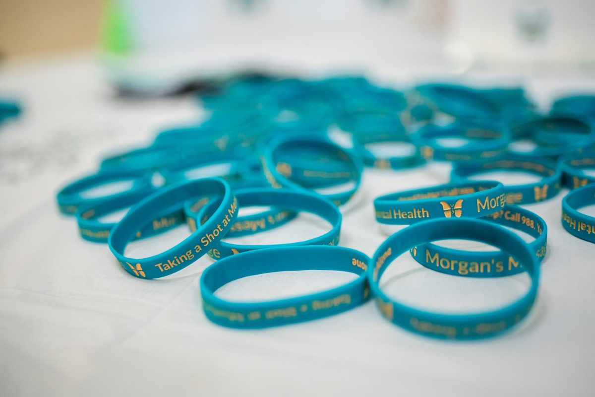 A display table at the event features Morgans Message wristbands. 