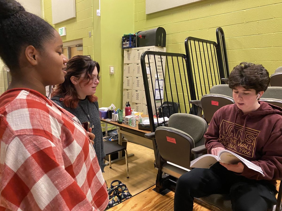 Senior Gabrielle Evans (left), junior Johanna Huggins (middle), and senior Finn Martinez (right) read through their Shrek script and run lines.