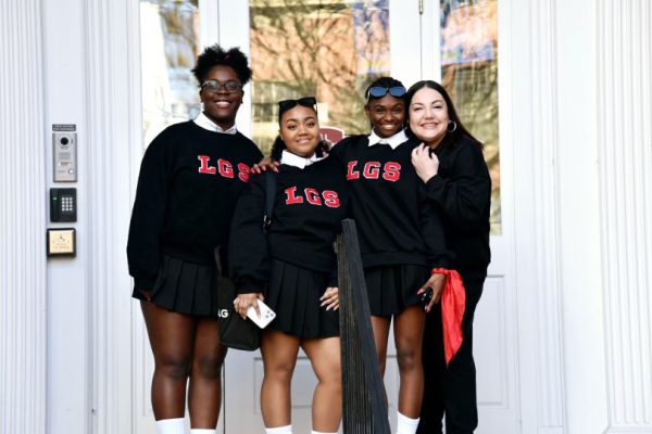 Three members of the Girls STEP Team and Co-Adviser Patricia Kolias pose in front of Winchester Hall where they performed for the Etched in History celebration of the signing of Civil Rights Act. (Courtesy of Patricia Kolias)