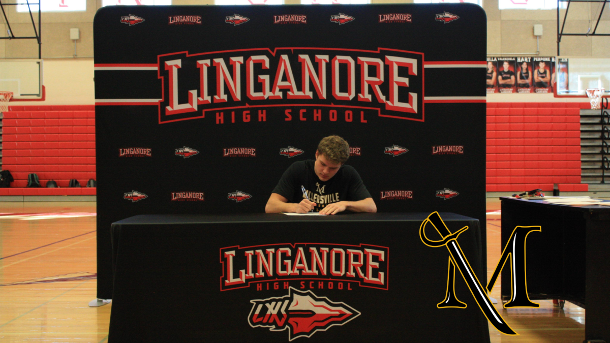 Mason Farster signs his National Letter of Intent to play football at Millersville University.