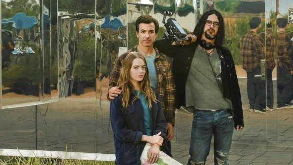 Asher, (Fielder) Whitney (Stone) and Dougie (Safdie) stand in front of one of Whitneys eco-friendly homes from the set of The Curse. (Showtime Networks, A24)