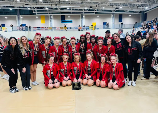 Linganore varsity cheer with their second place plaque.