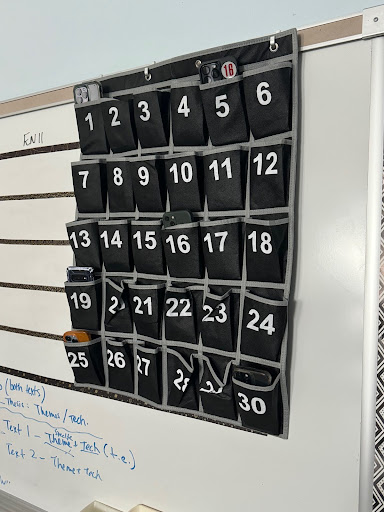 Students put their phones into the phone jail in order to keep them off of social media during class.