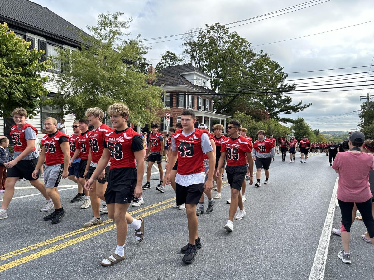 The Linganore varsity football team represents in the Homecoming parade the weekend before their Homecoming game against the Oakdale Bears on September 27.