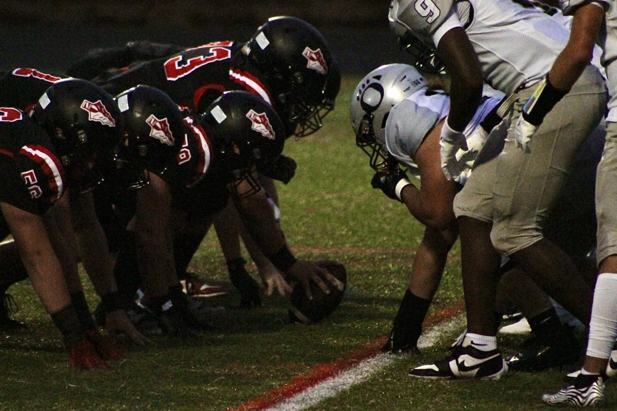 Linganore Lancers face off against the Oakdale Bears at the line of scrimmage.