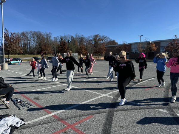 The group of participants dancing after learning the Christmas combo during Cara Morgan's service project. 