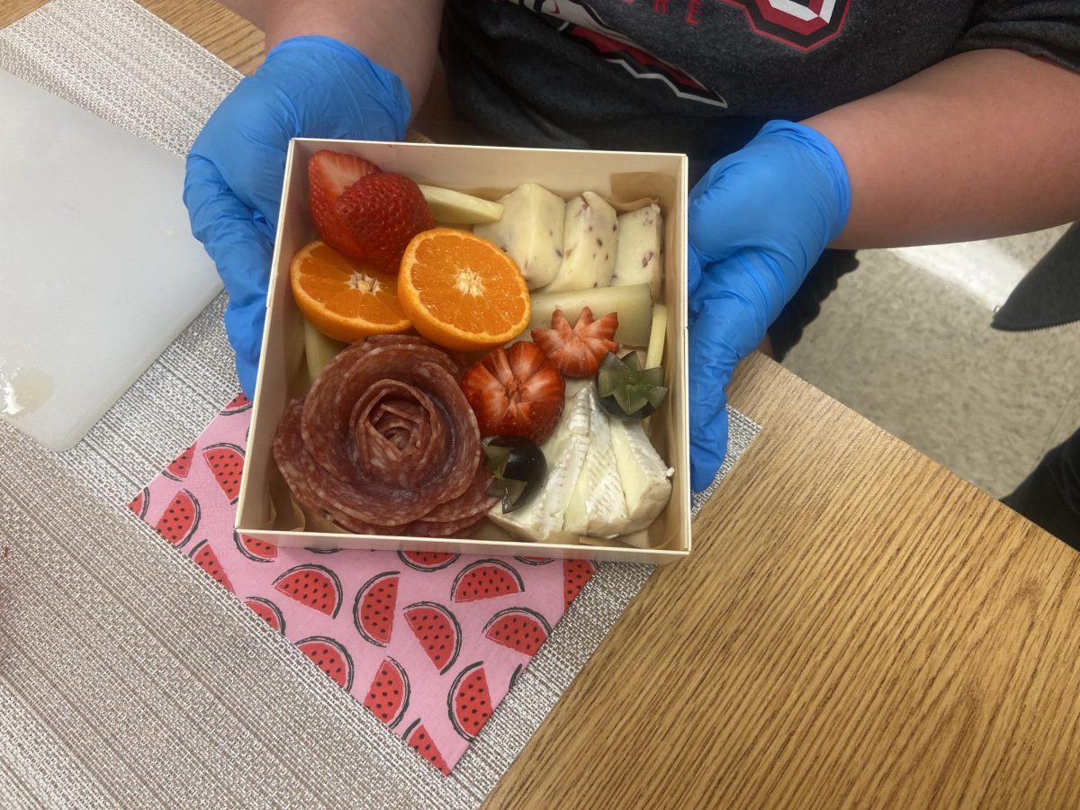 L4L student holding a charcuterie box that they made with Mrs.O