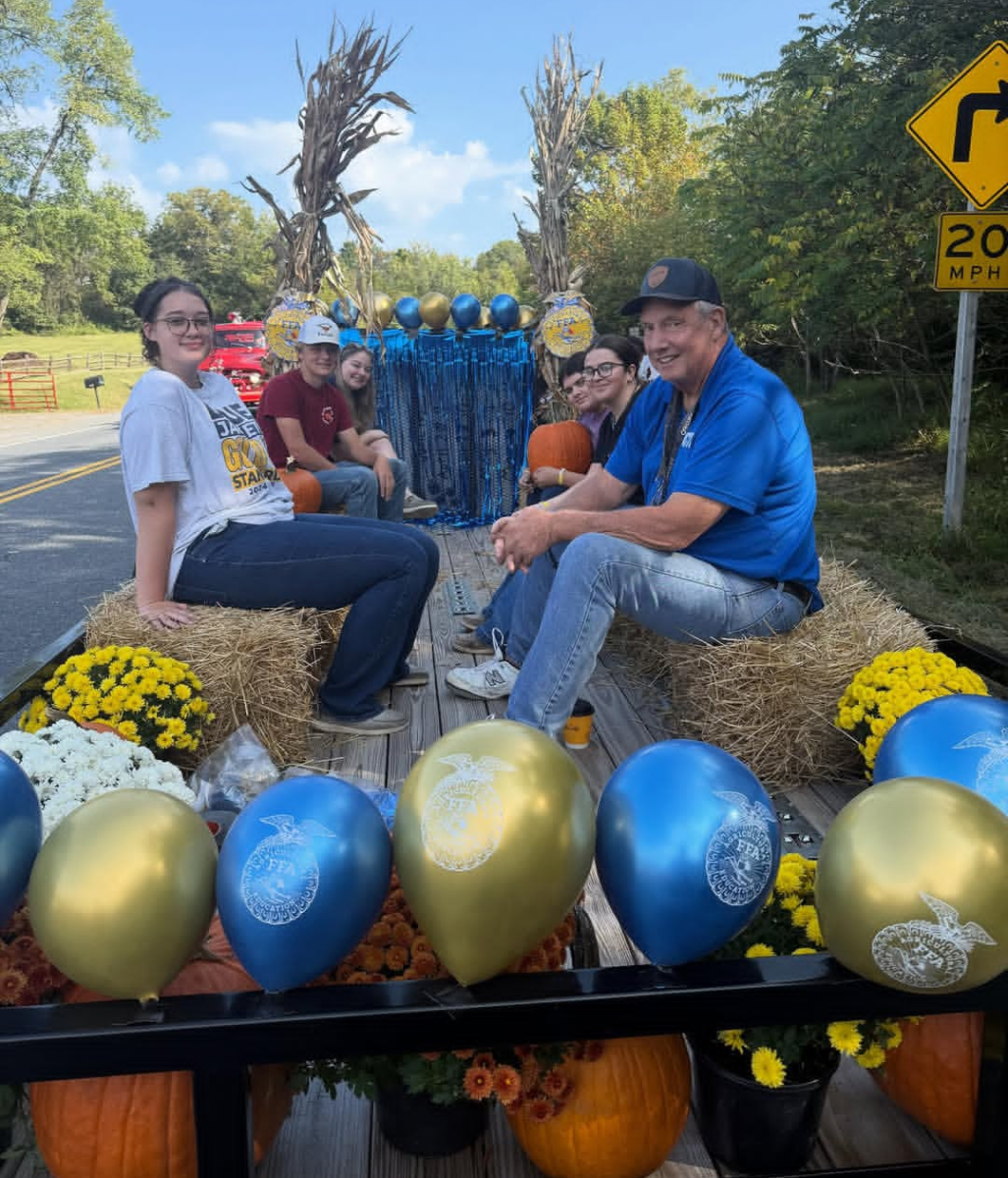 The Lingnanore Future Farmers of America (FFA) use their Homecoming Parade float to promote the Linganore community show. 