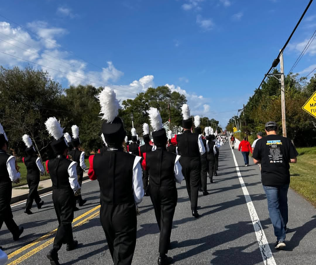 The marching band walks down mainstreet during the homecoming parade