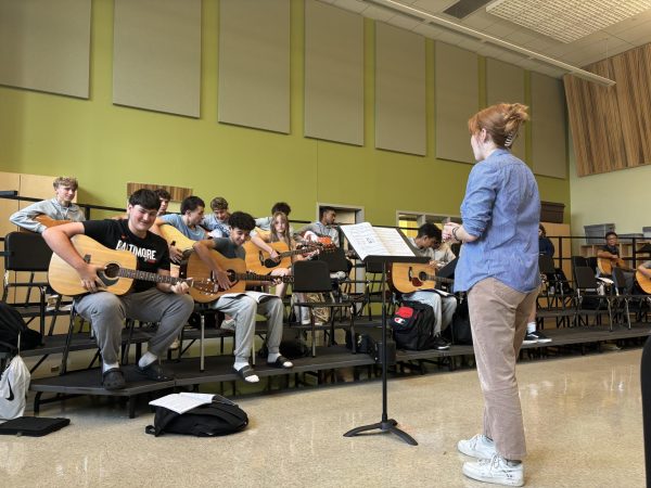 New music Teacher McKenzie Berry teaching guitar 1.