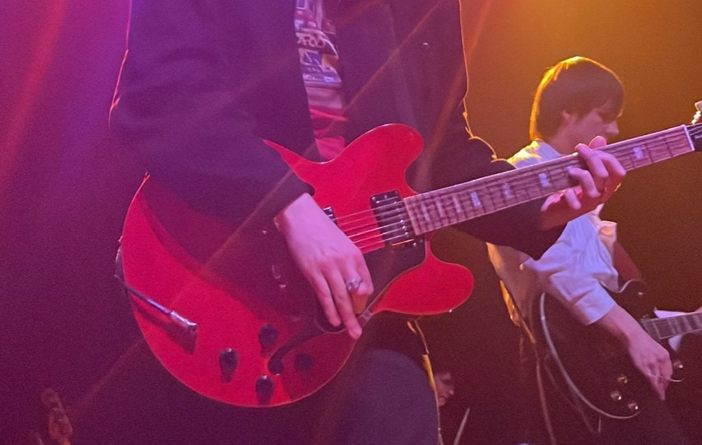 Harry Ruprecht of the Backfires plays guitar at a show.