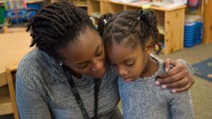A woman displays empathy by comforting a sad little girl. (Used with permission - Photo by Hamdi Kandi Studio)