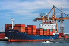 A container ship being docked at its port containing goods from other countries. 