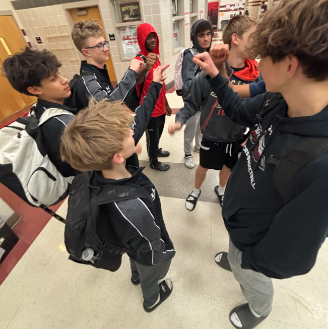 Linganore Boys JV basketball team huddles before boarding the bus to TJ High