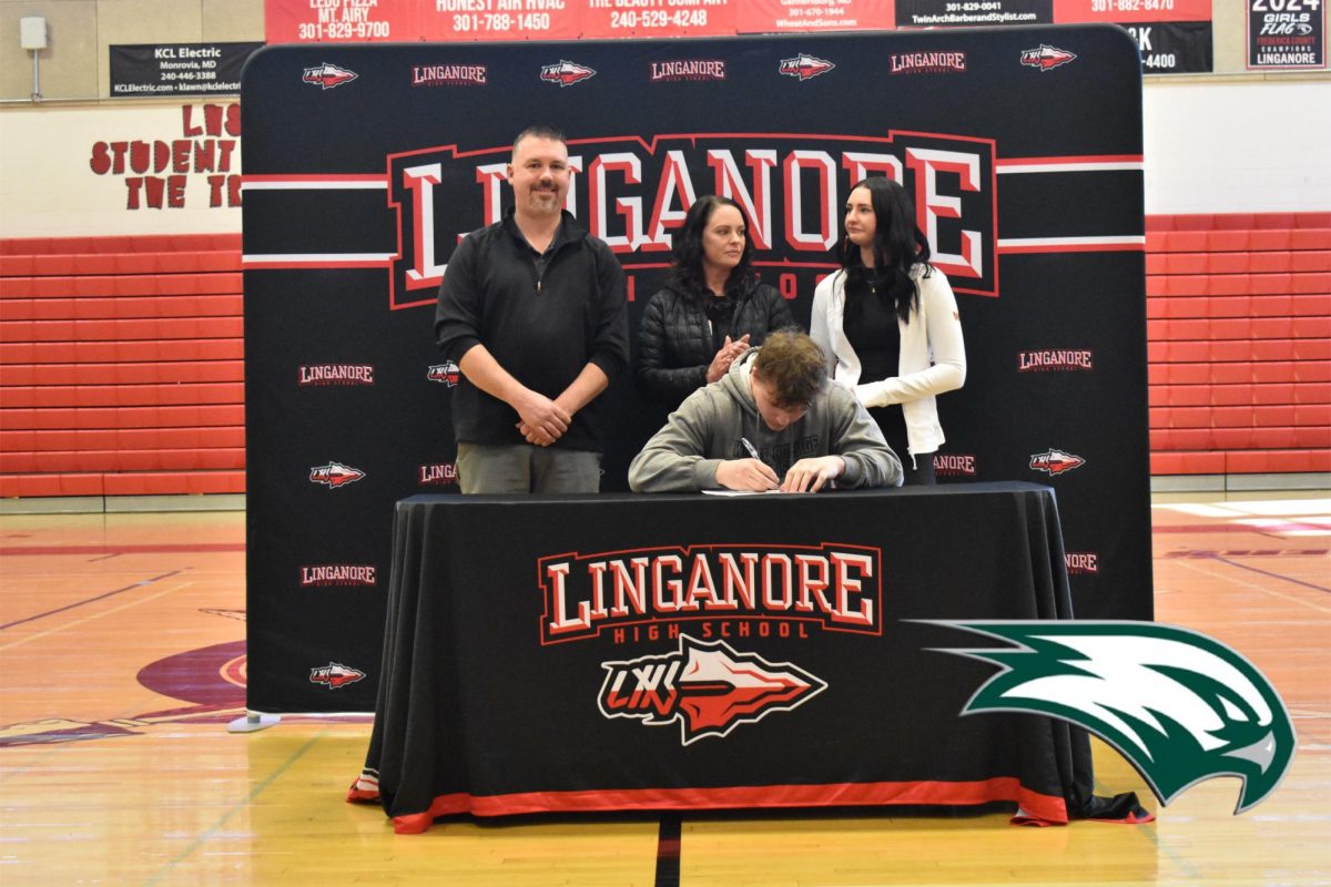 Landon Allen signs his National Letter of Intent to continue playing football at Wagner College.