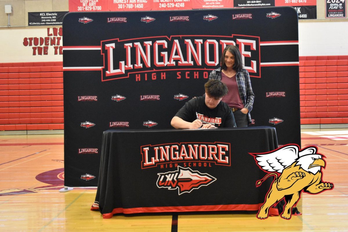 Isaac Ferarri signs his National Letter of Intent to continue playing football at Seton Hill University.