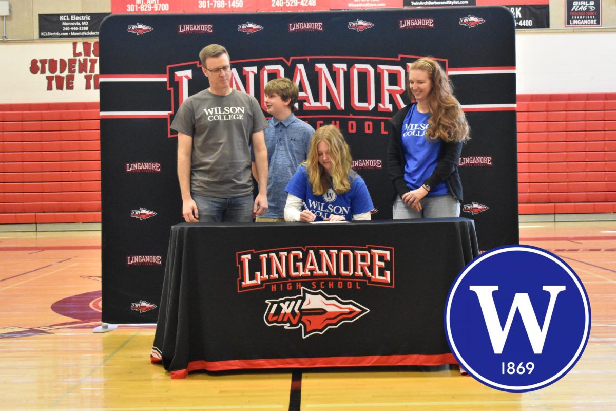 Charlotte Grimes signs her National Letter of Intent to continue her soccer career at Wilson College.