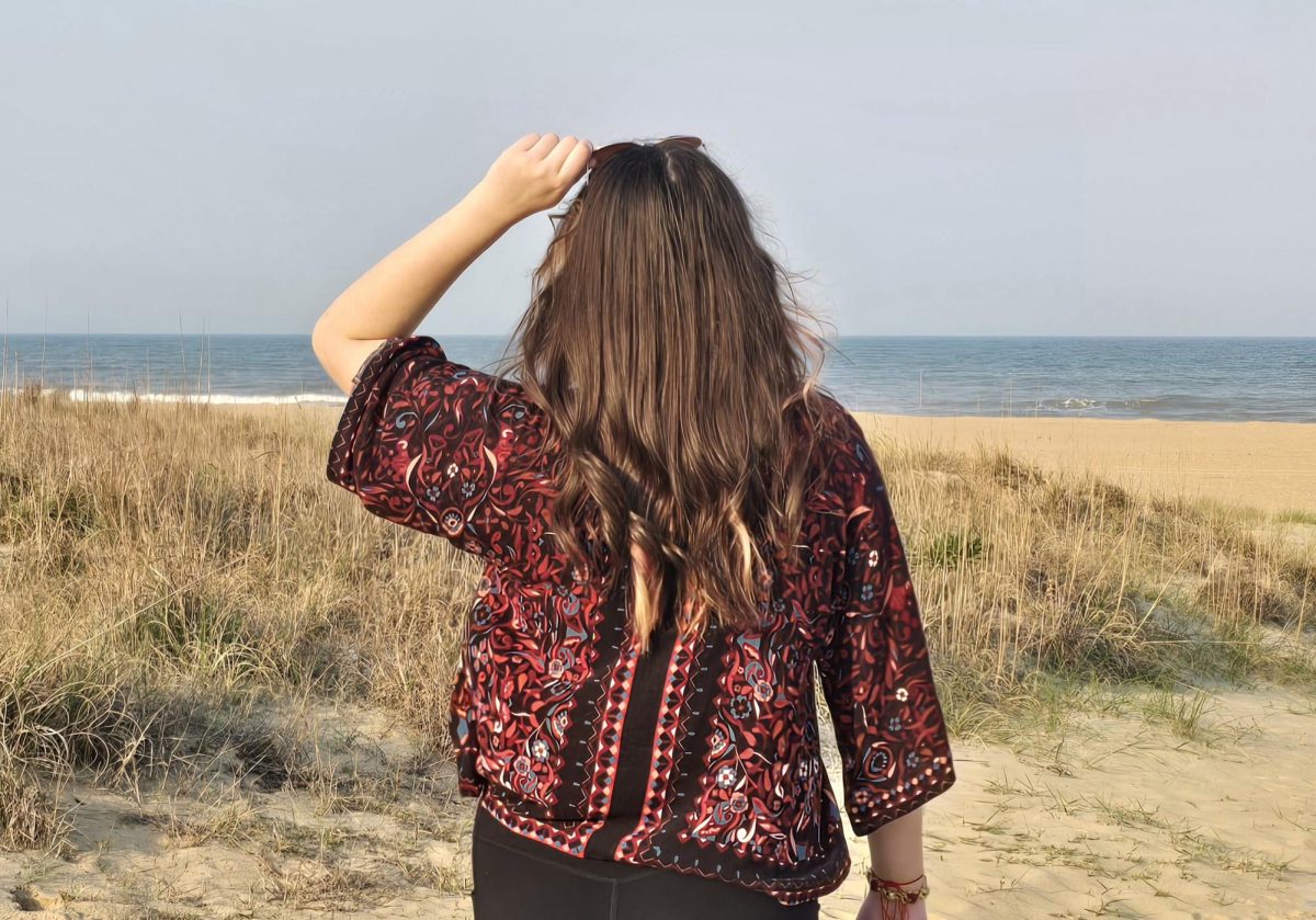 A woman at the beach shows off her hairstyle.