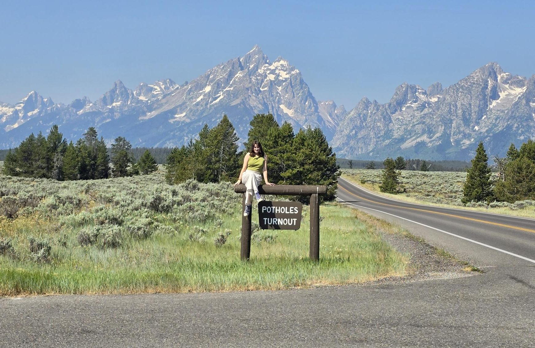Jenna Ablondi admires the view of Grand Teton National Park in a road turnout. Overlooks like these are common in scenic national parks (Used with permission – Photo by Rachel Ablondi).